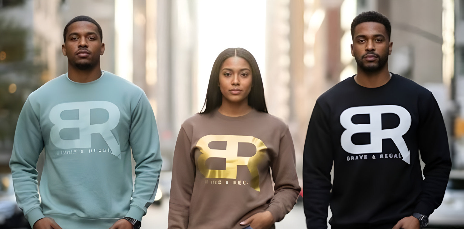 Three individuals wearing branded sweatshirts with large BR logos walk confidently down a city street.