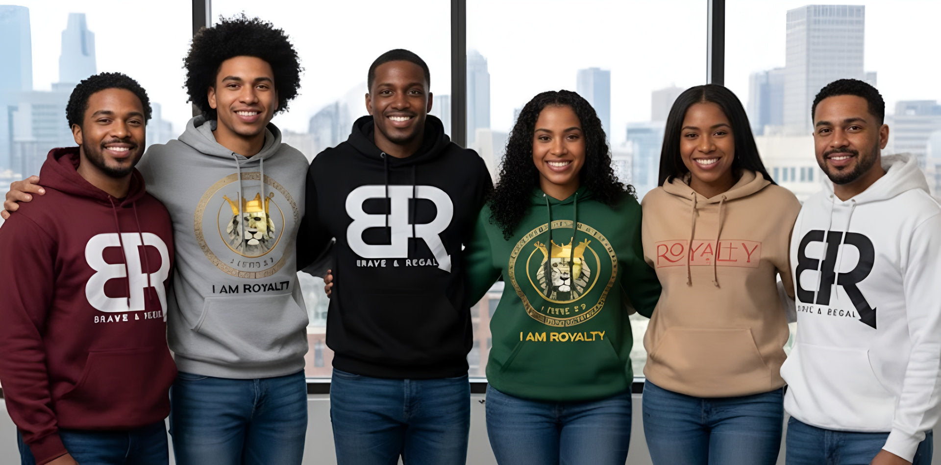 Group of six people wearing colorful hoodies with Brave & Regal and I Am Royalty logos, standing in front of cityscape.