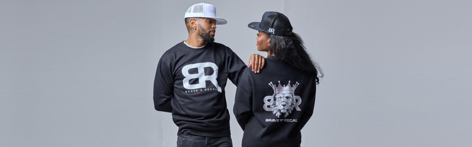 Two individuals model matching black sweatshirts with a 